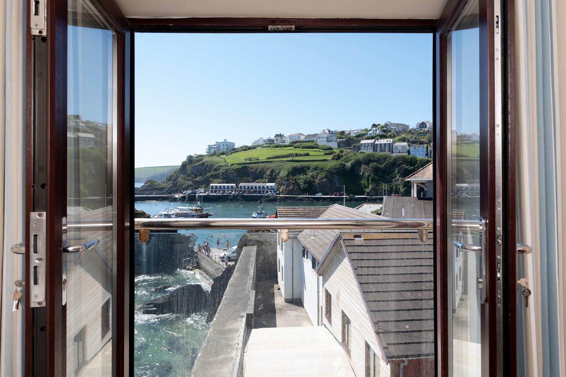 Enjoy sea views of the quaint harbour at any time of day from your balcony.