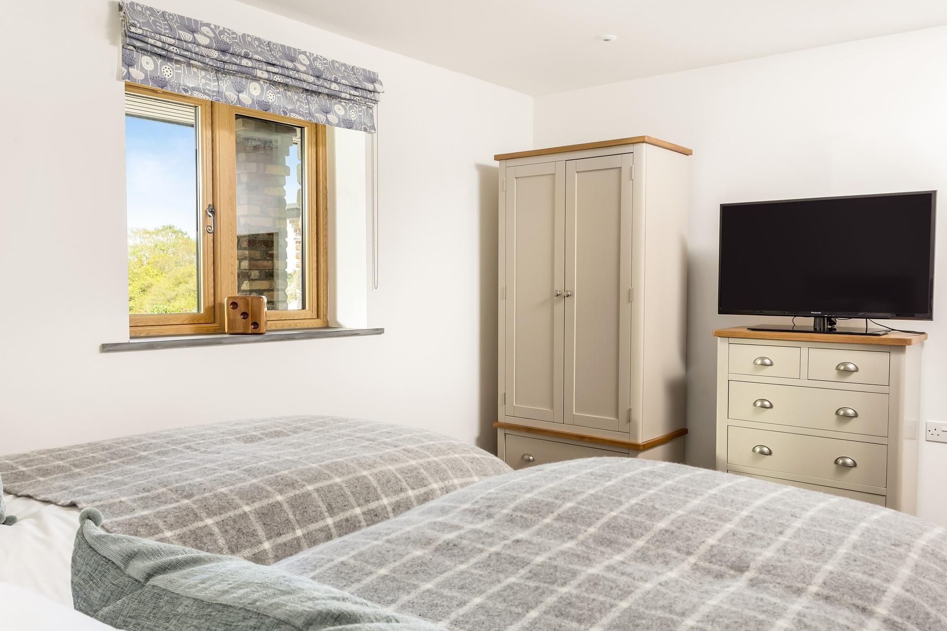 Bedroom 2 has a wardrobe, a chest of five drawers, and plenty of storage for holiday clothes.