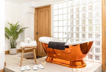 Sink into the bubbles in the copper bath complete with mood lighting for the ultimate indulgent evening.