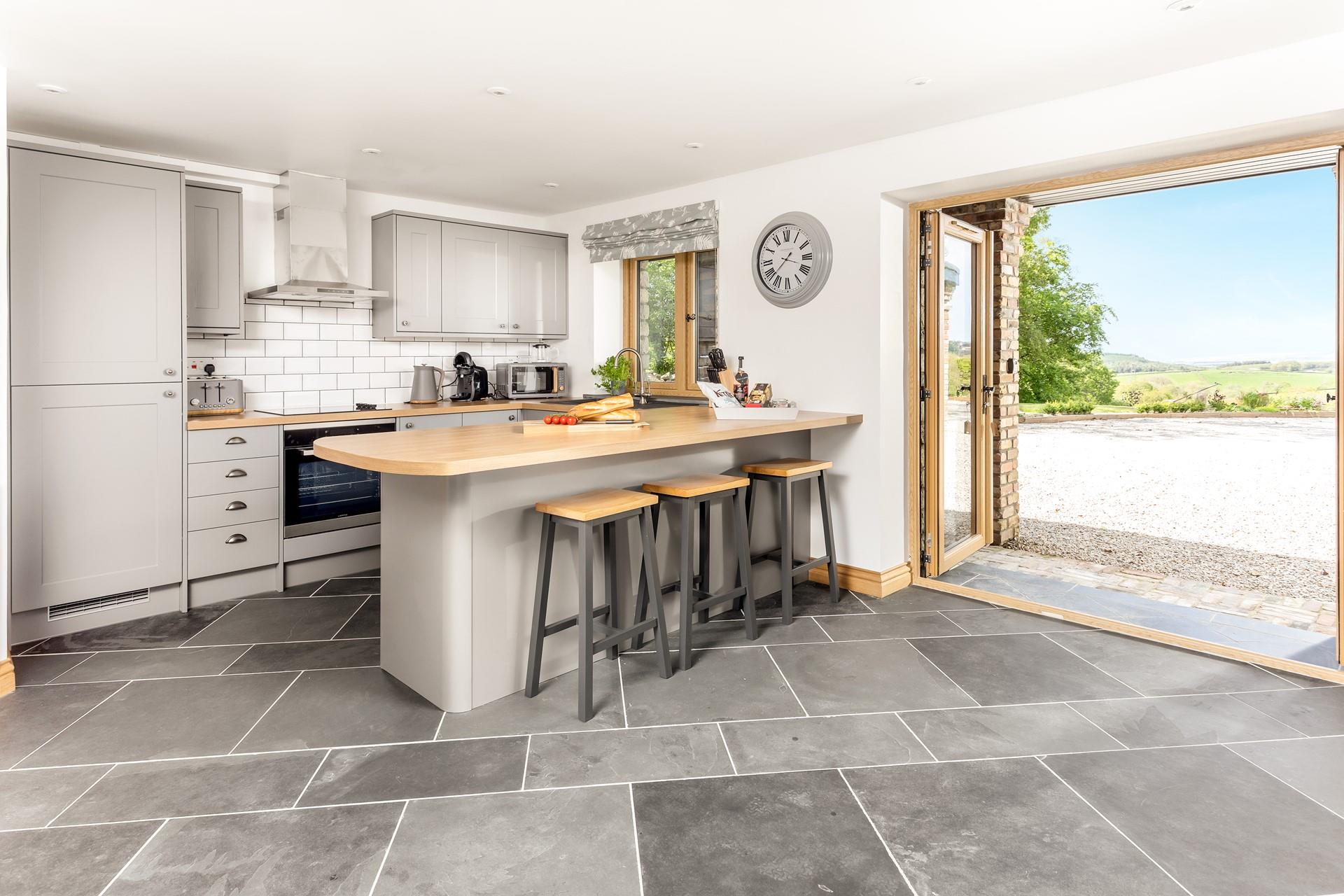 Open the doors and let the fresh countryside breeze run through the home as you cook in the modern kitchen.