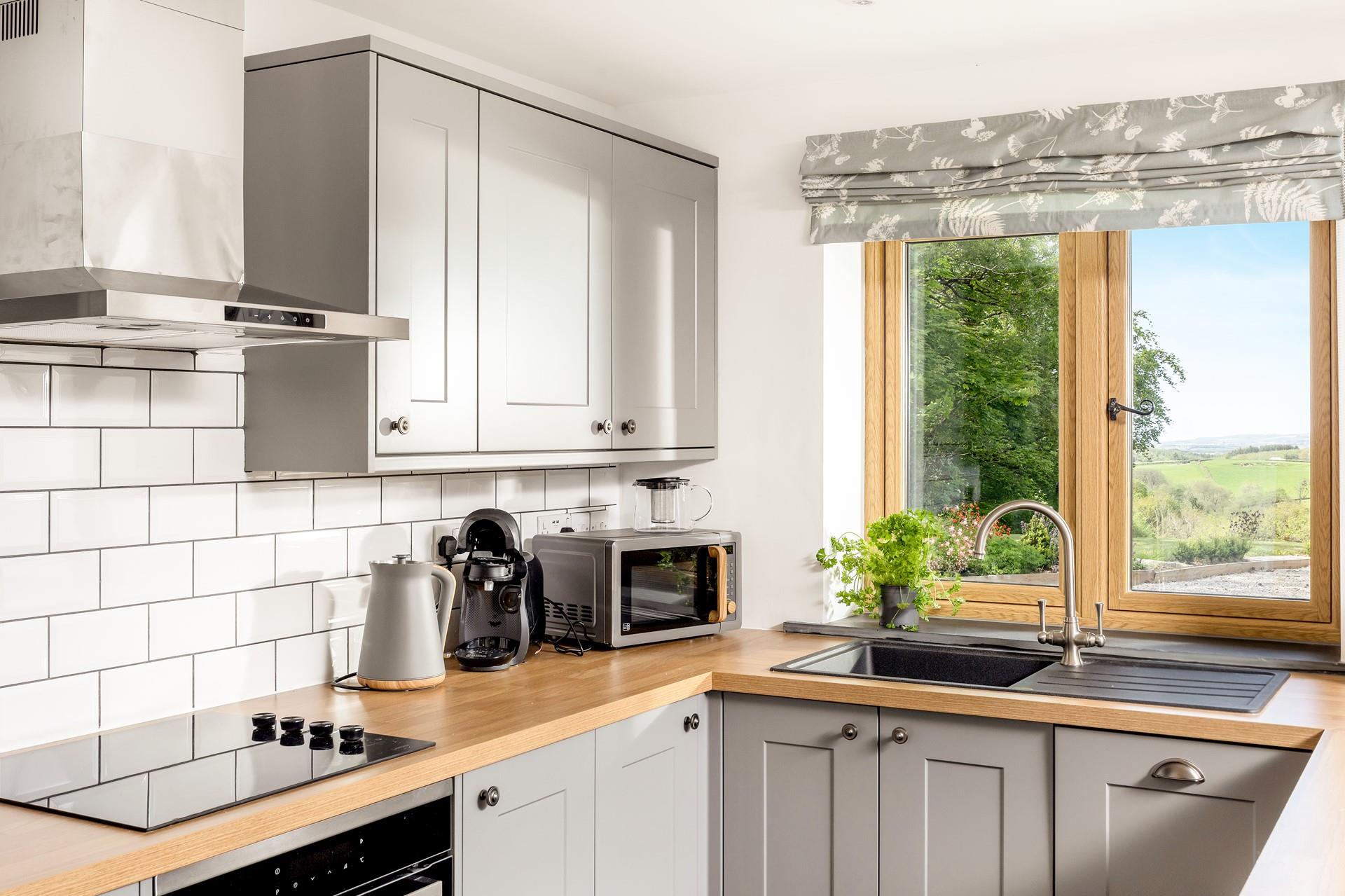 The view from the kitchen overlooks Whitstone Woods and miles in the distance, you can even see the sea!