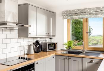 The view from the kitchen overlooks Whitstone Woods and miles in the distance, you can even see the sea!