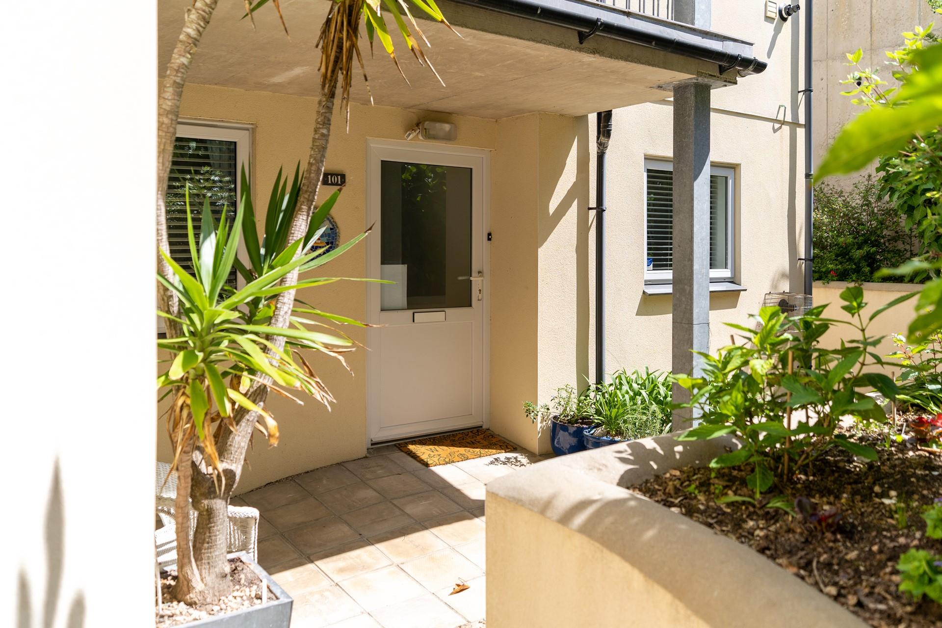 The entrance to Castaways is surrounded by greenery and Cornish palms.