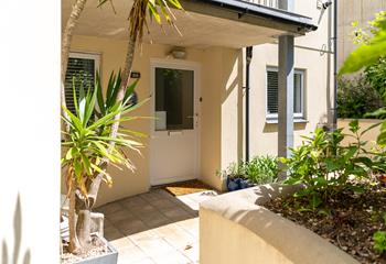 The entrance to Castaways is surrounded by greenery and Cornish palms.