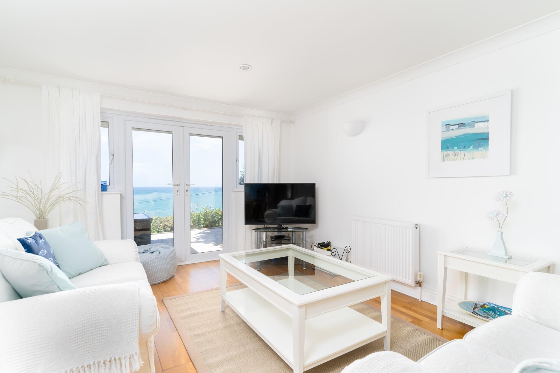 The sitting room is perfect for relaxing in, while still being able to watch over the blue waters. 