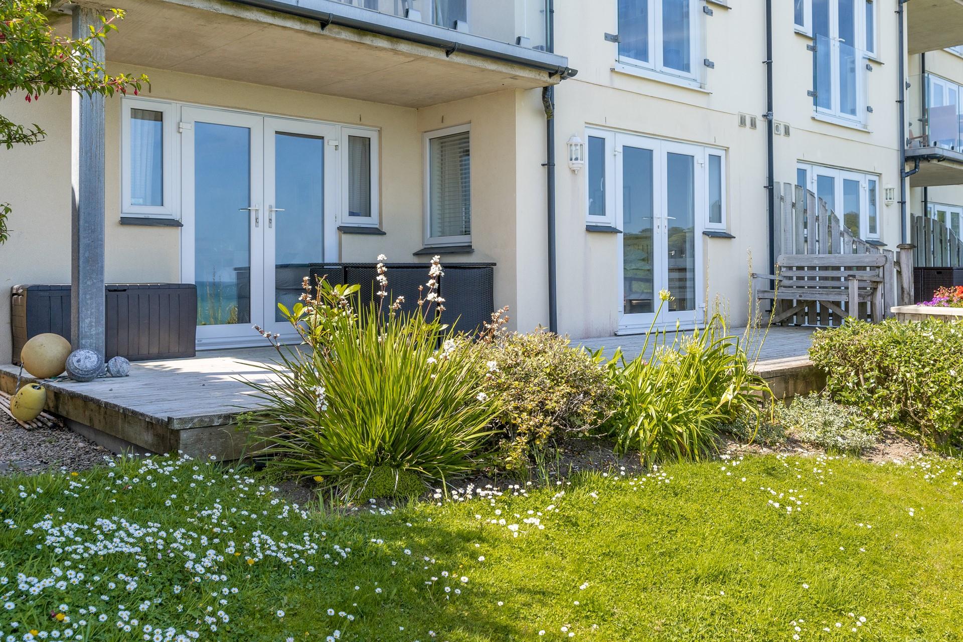 The large decking area is ideal for dining al fresco or sitting together with the family overlooking the sea. 