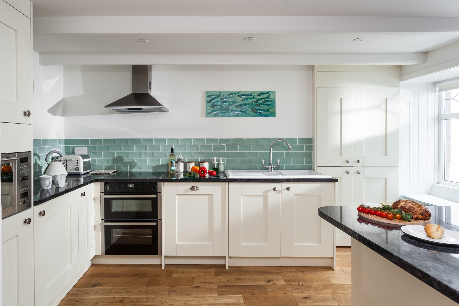 The modern kitchen is well-equipped for the chef of a family to cook up a storm.