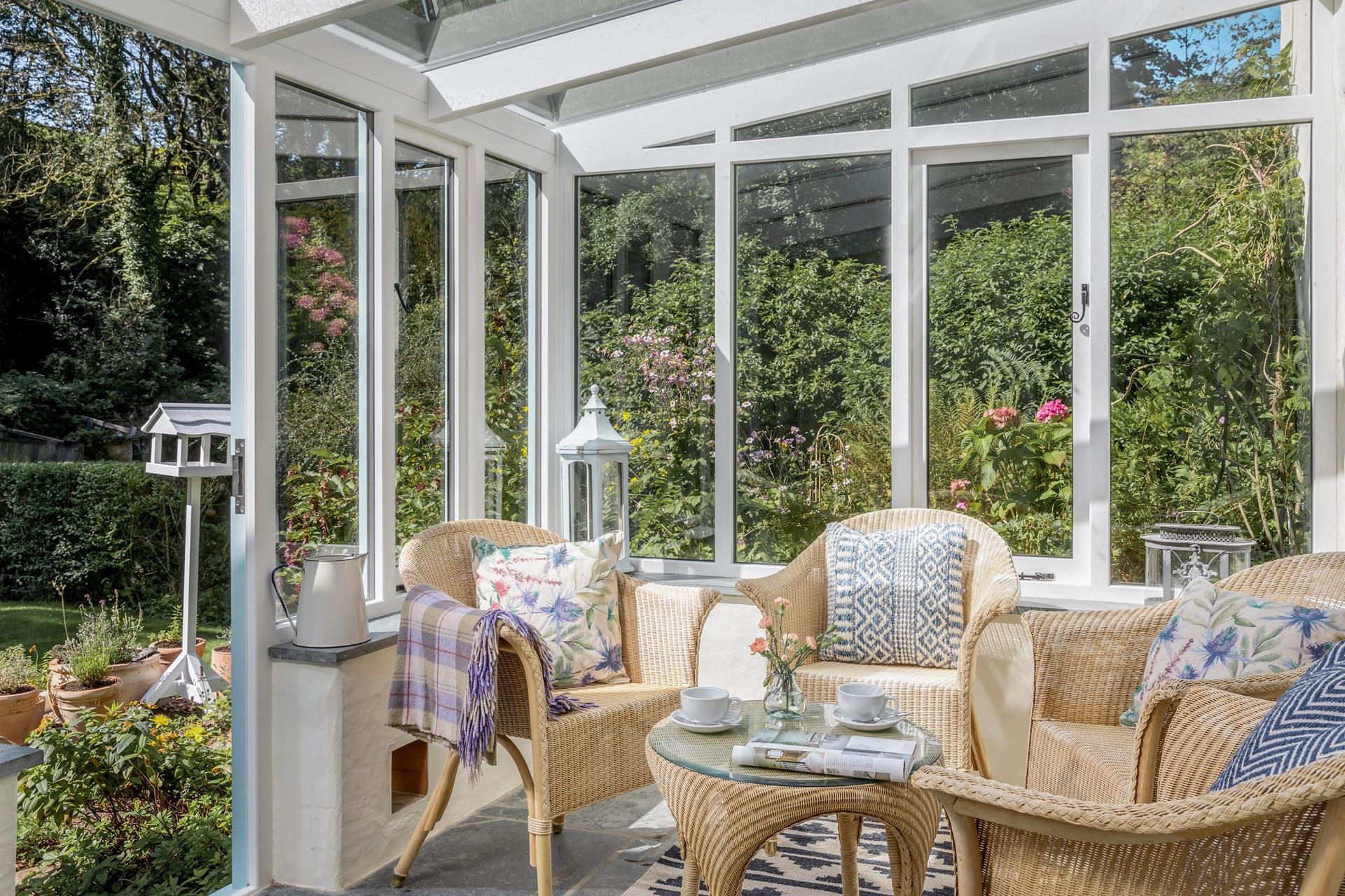 The sunny conservatory leads down to a quaint stream.