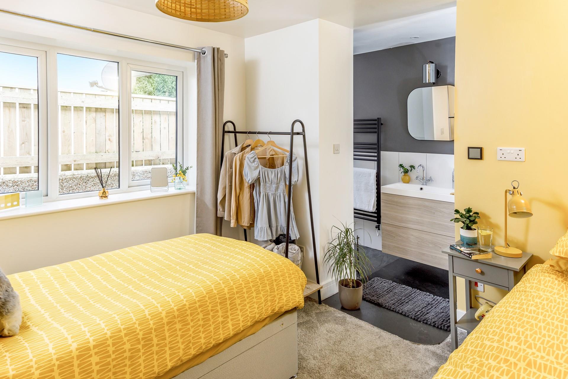 The twin room is bright with seaside yellow tones.