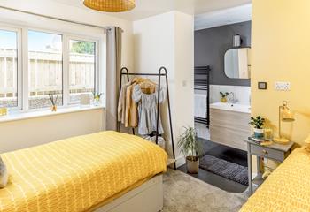 The twin room is bright with seaside yellow tones.