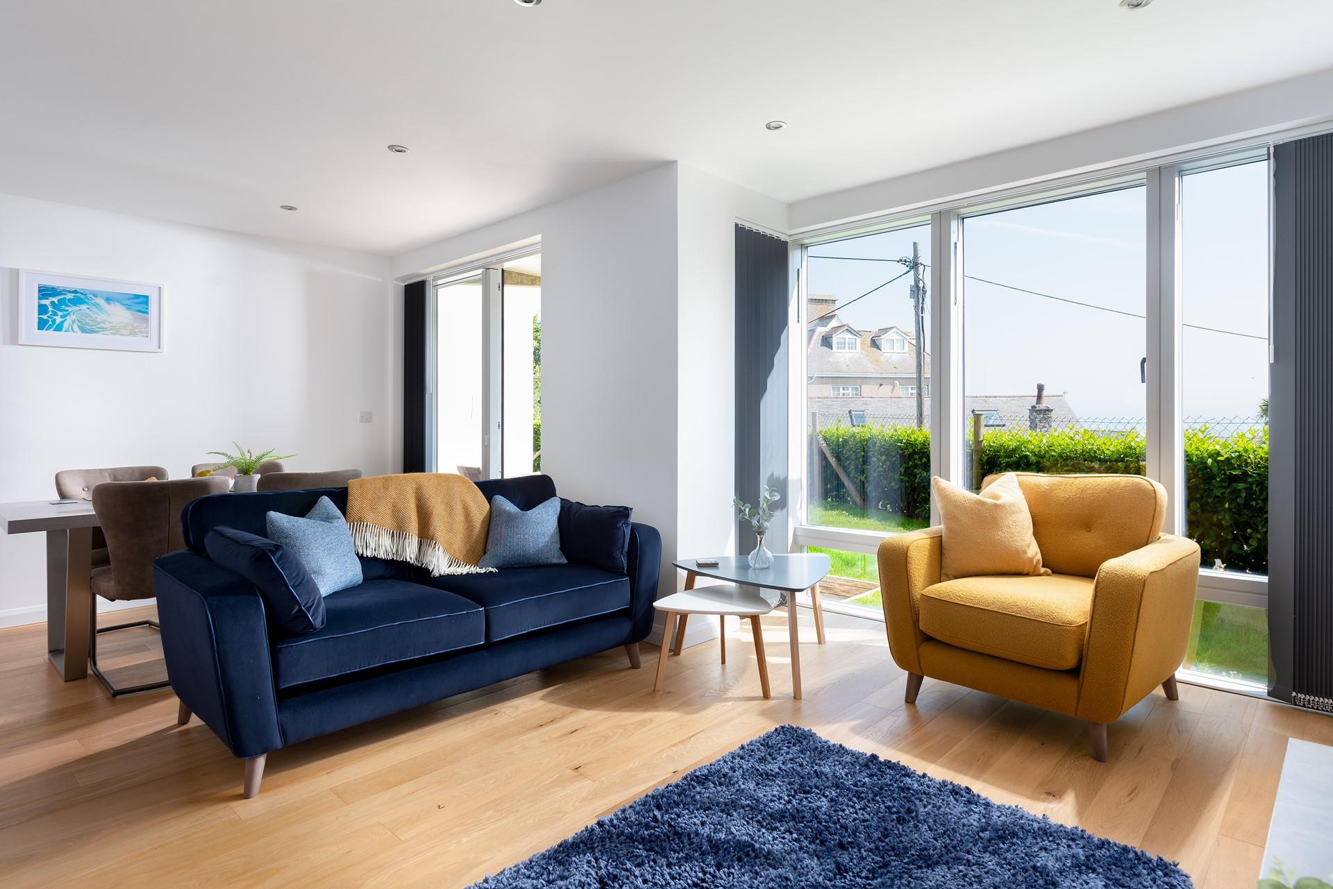 Look out at the sea as the sun comes down with a glass of wine in hand.