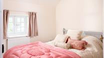 Bedroom 4 has a spacious king size bed and is perfectly cosy for a relaxing night's slumber.