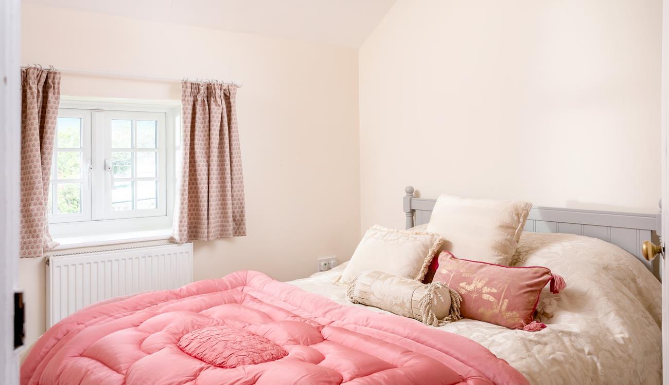 Bedroom 4 has a spacious king size bed and is perfectly cosy for a relaxing night's slumber.