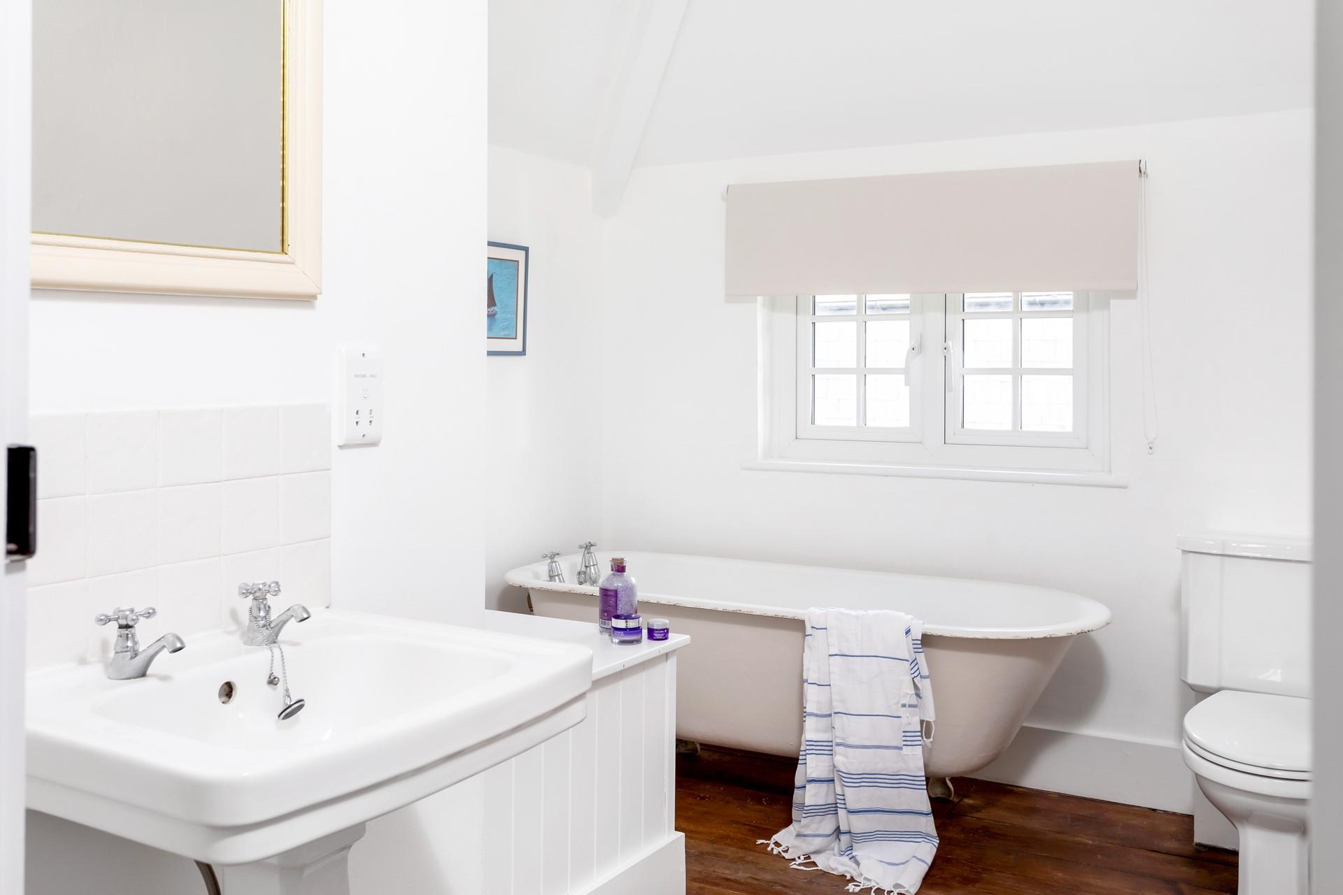 The family bathroom has a traditional claw foot freestanding bath for luxurious soaks.