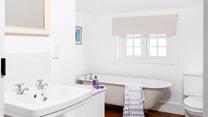 The family bathroom has a traditional claw foot freestanding bath for luxurious soaks.