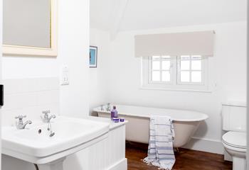 The family bathroom has a traditional claw foot freestanding bath for luxurious soaks.