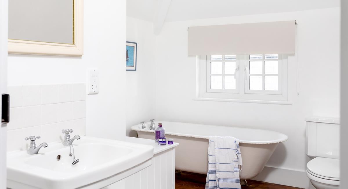 The family bathroom has a traditional claw foot freestanding bath for luxurious soaks.