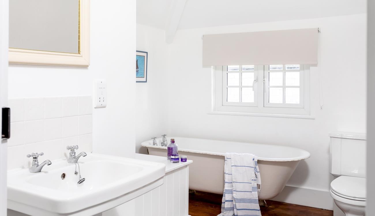 The family bathroom has a traditional claw foot freestanding bath for luxurious soaks.