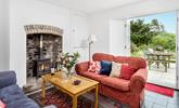Snuggle up in front of the woodburner on chilly evenings on the sumptuous sofa. - Thumbnail Image
