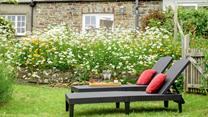 The rattan furniture is perfect for sunbathing on quiet days spent in the garden.
