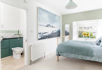 Bedroom 1 is decorated with calming blue and green tones.