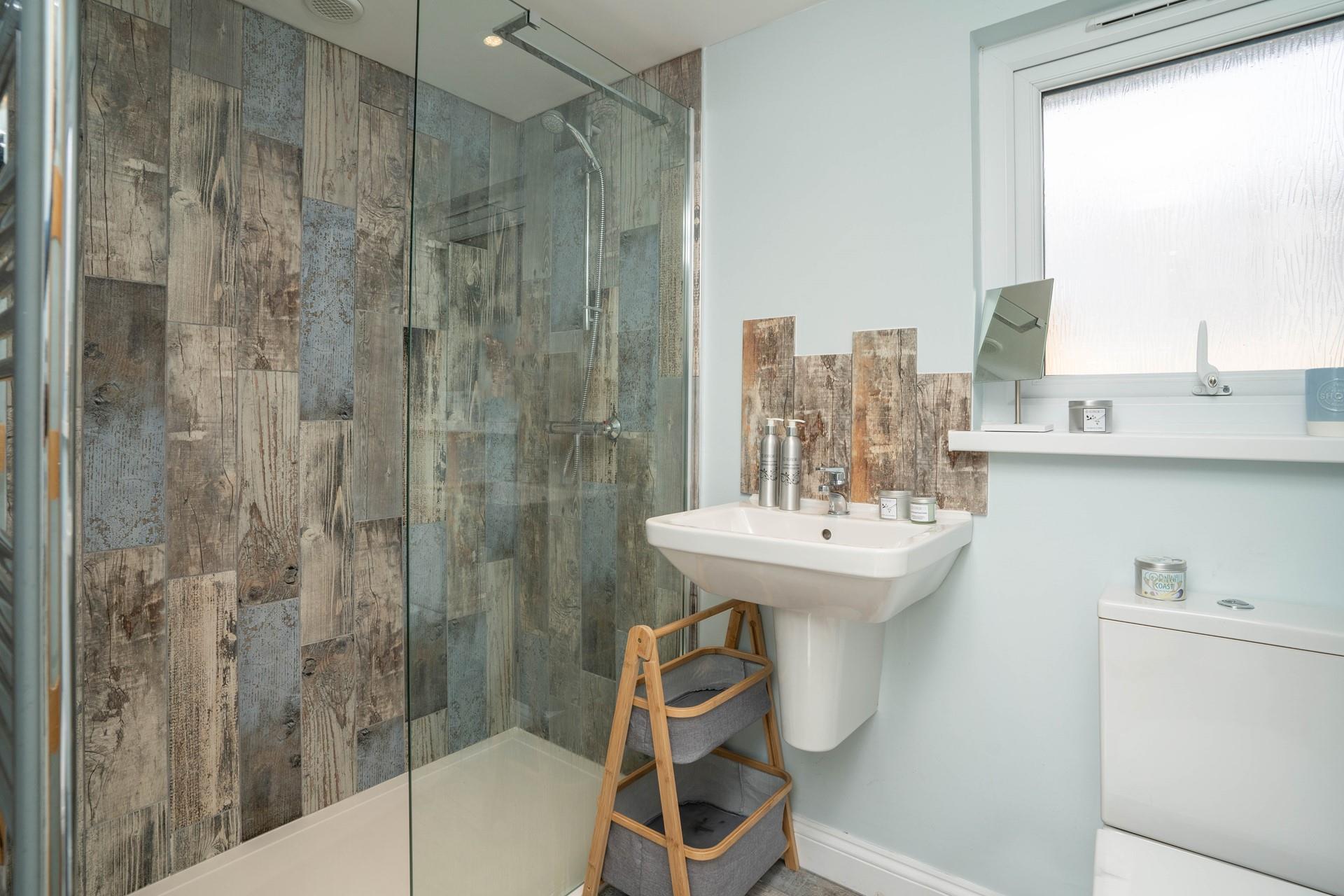 The contemporary en suite shower room is perfect for washing off sandy toes.