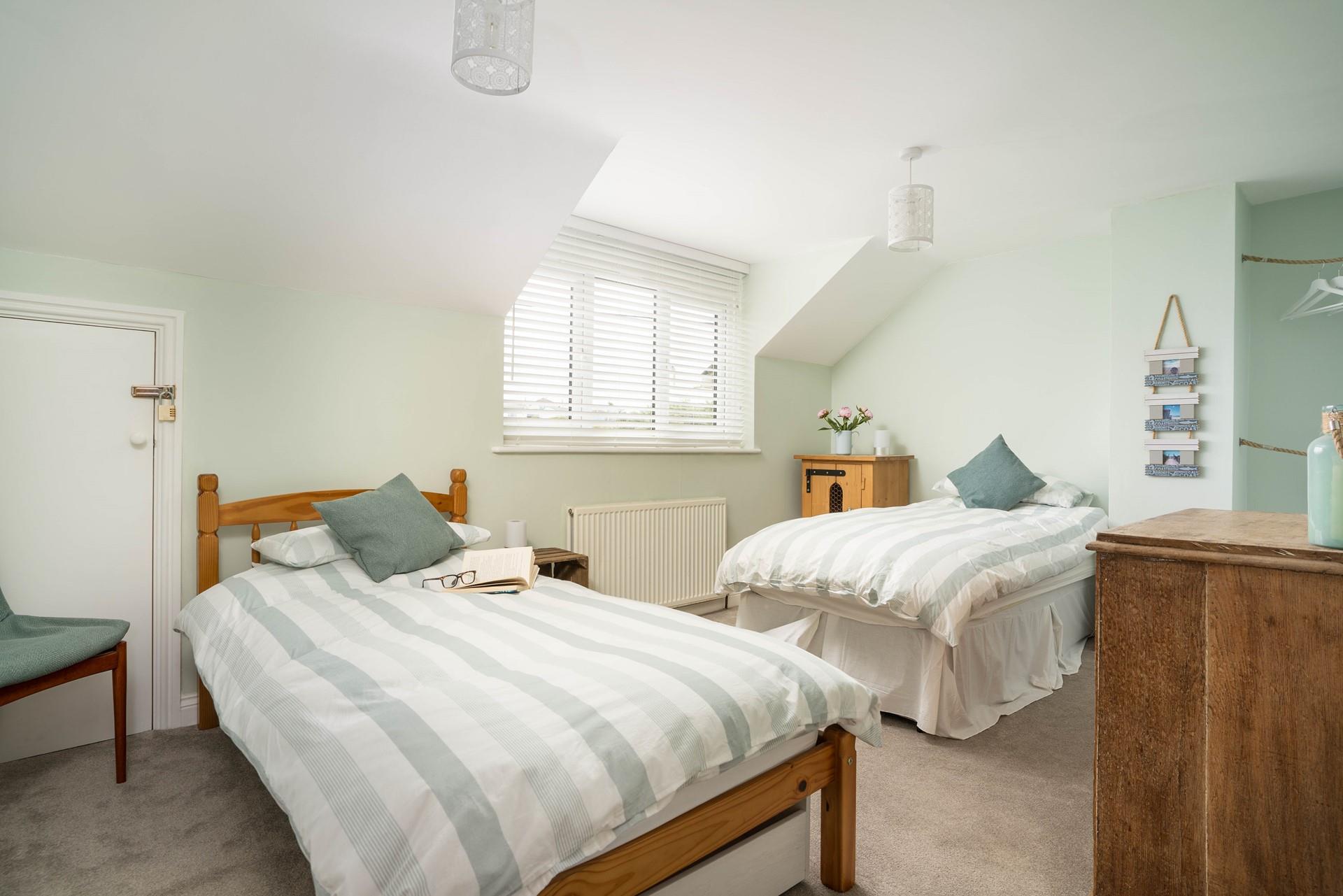 Bedroom 3 has twin beds perfect for young adults or children to settle into each night.