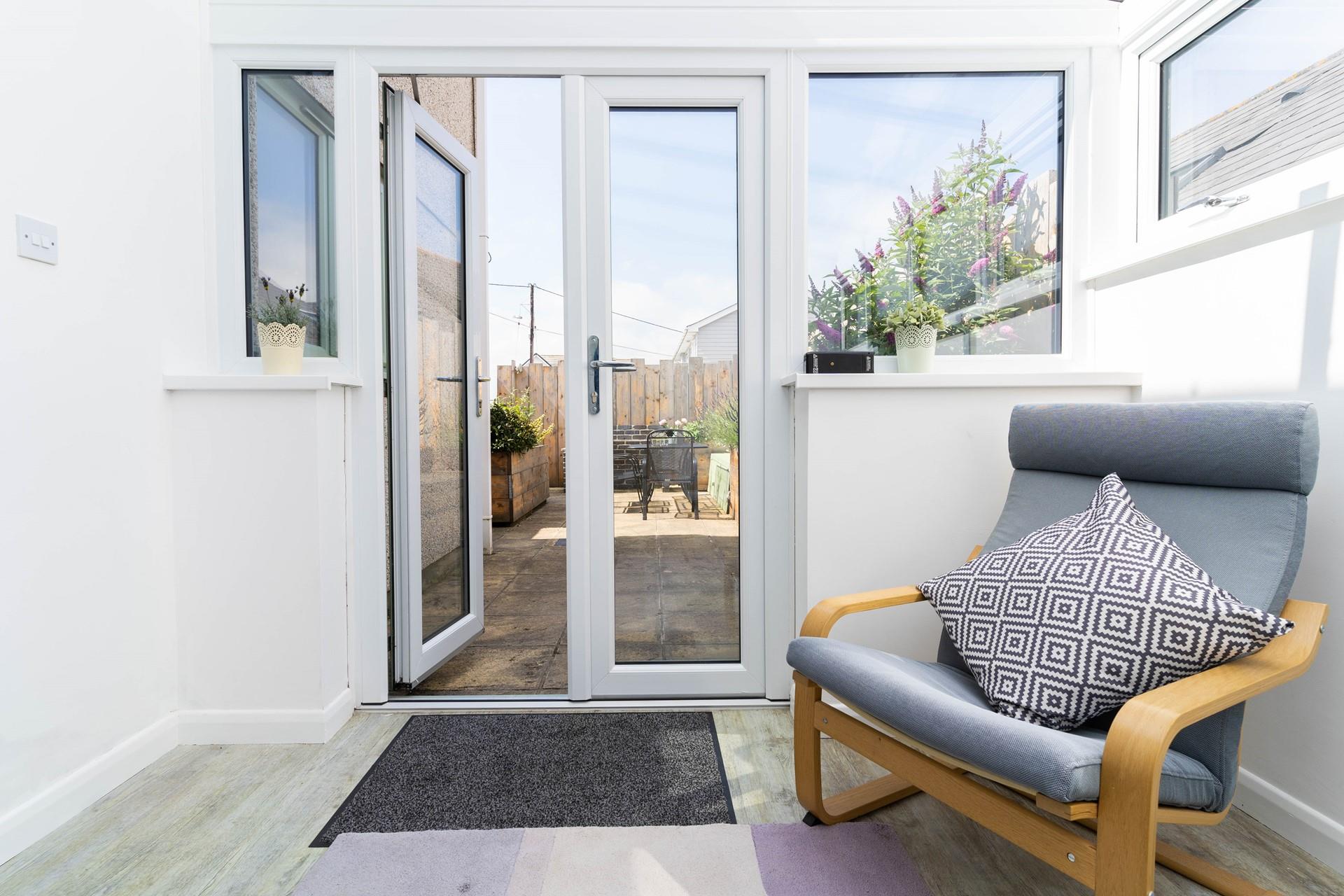 The conservatory leads out onto the enclosed rear patio.