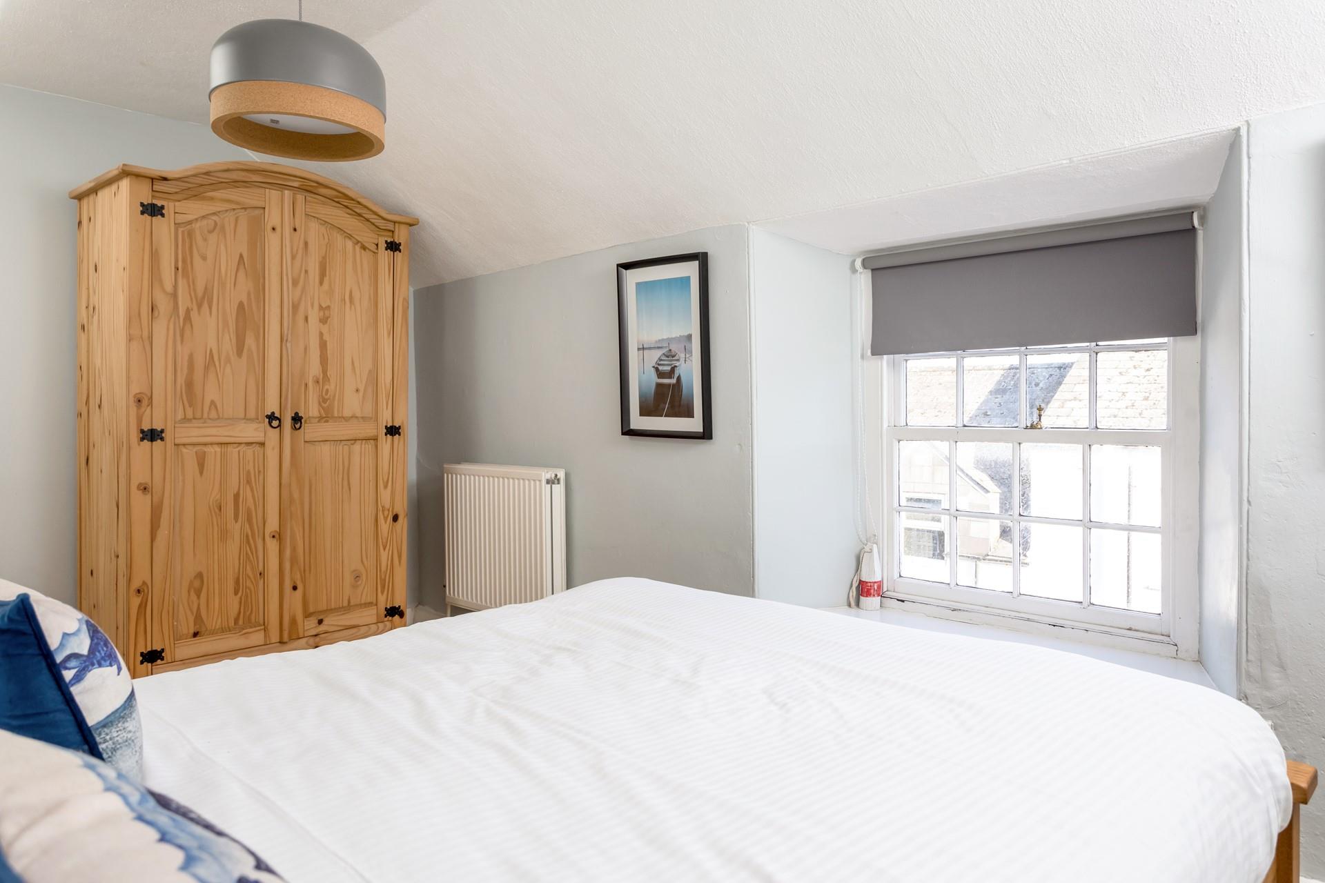 Bring clothes for every weather eventuality and unpack them into the wooden wardrobe.