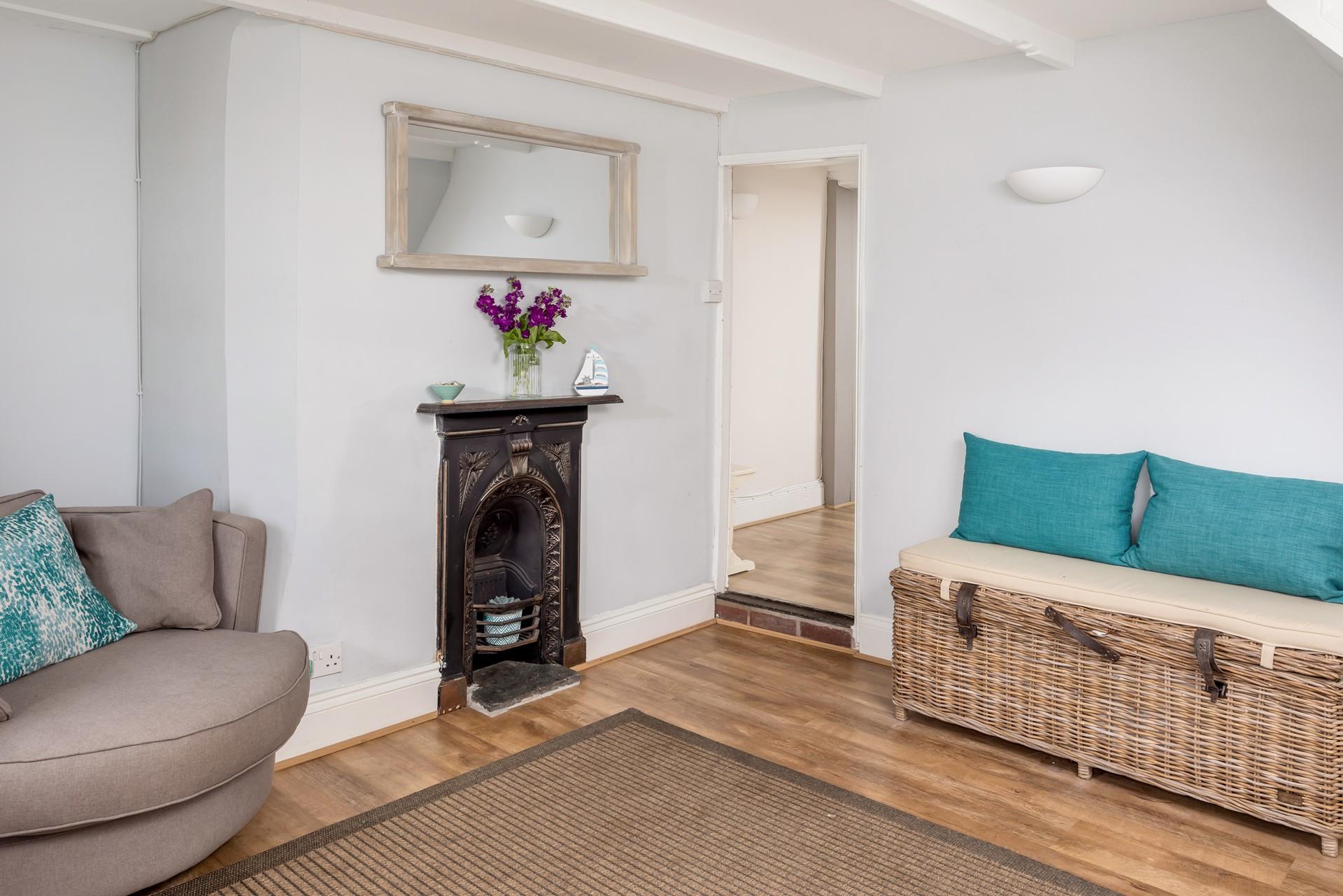 There is a staircase leading to bedroom 1, and then a step that leads through to the sitting room.