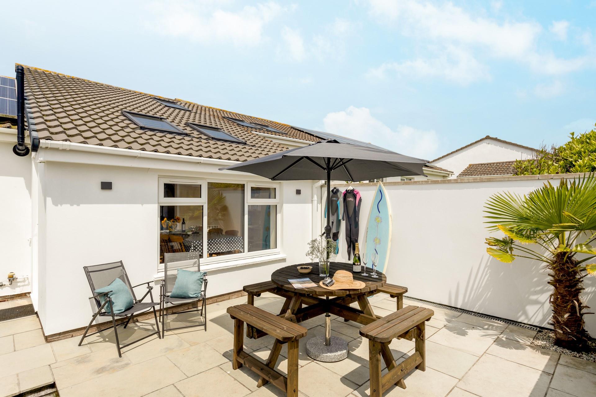 Dry off wetsuits in the suntrap garden after a day of surfing on the beach.