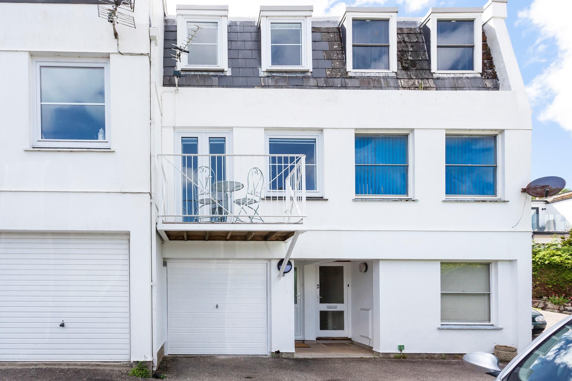 With a parking space opposite for a small to medium-sized car, there is also plenty of room to store bikes and surfboards in the garage.