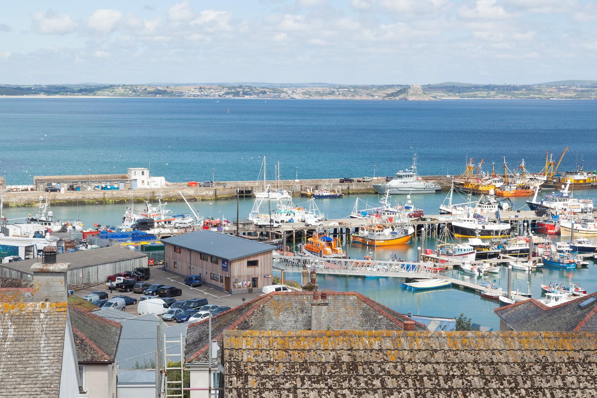 Watch over the activity of the colourful boats in Newlyn Harbour. 