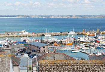 Watch over the activity of the colourful boats in Newlyn Harbour. 