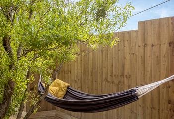 Spend lazy summer days with a good book swinging in the hammock.