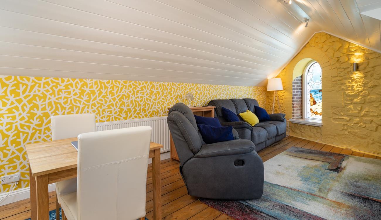 Relax on your reclining sofa with a cup of tea in hand.