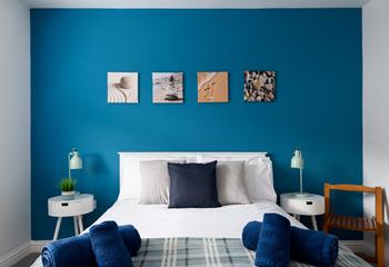 The bedroom has a blue theme reflecting the seaside location.