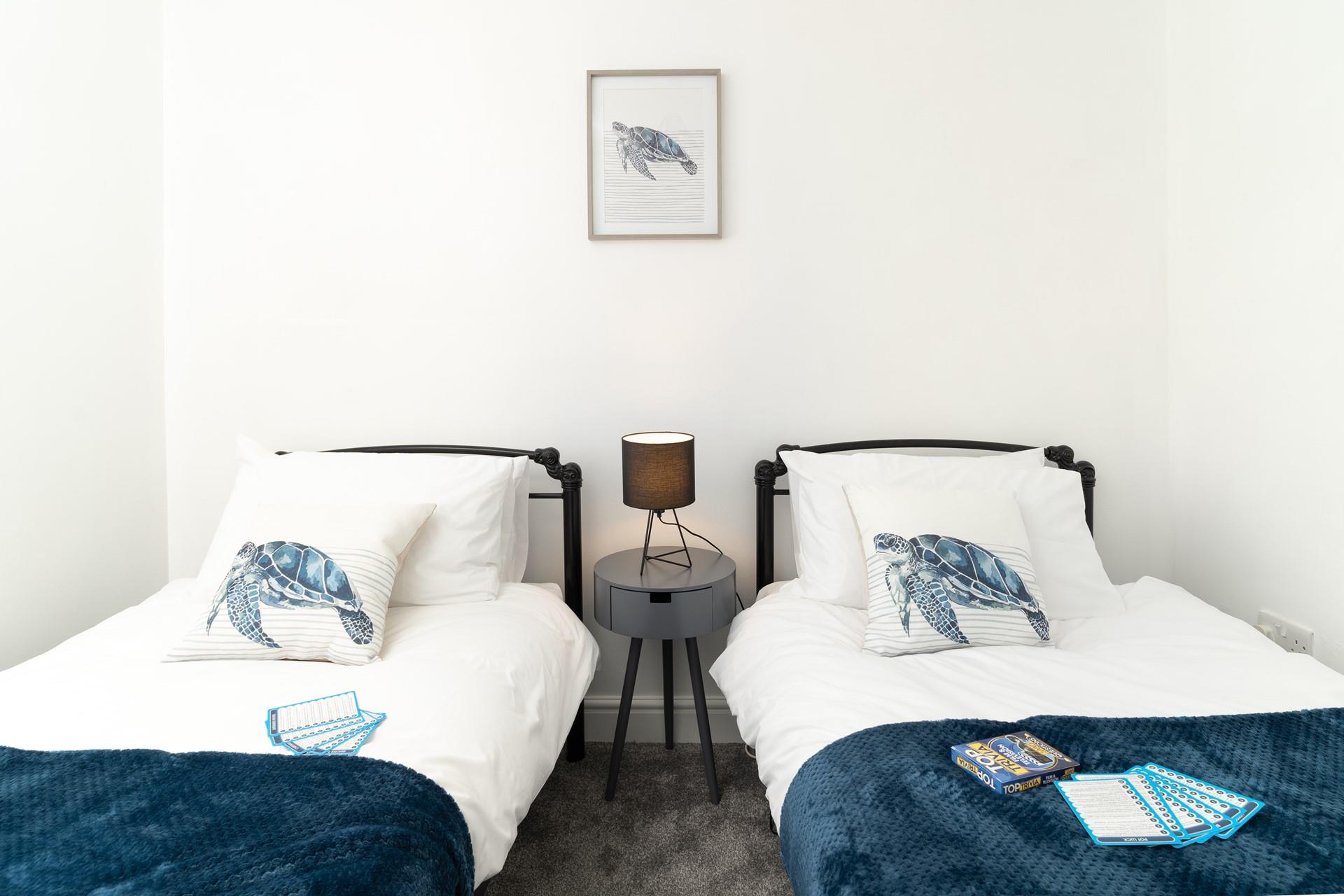 Coastal blues adorn the twin bedroom.