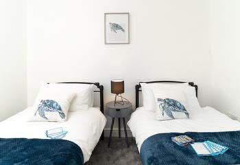 Coastal blues adorn the twin bedroom.