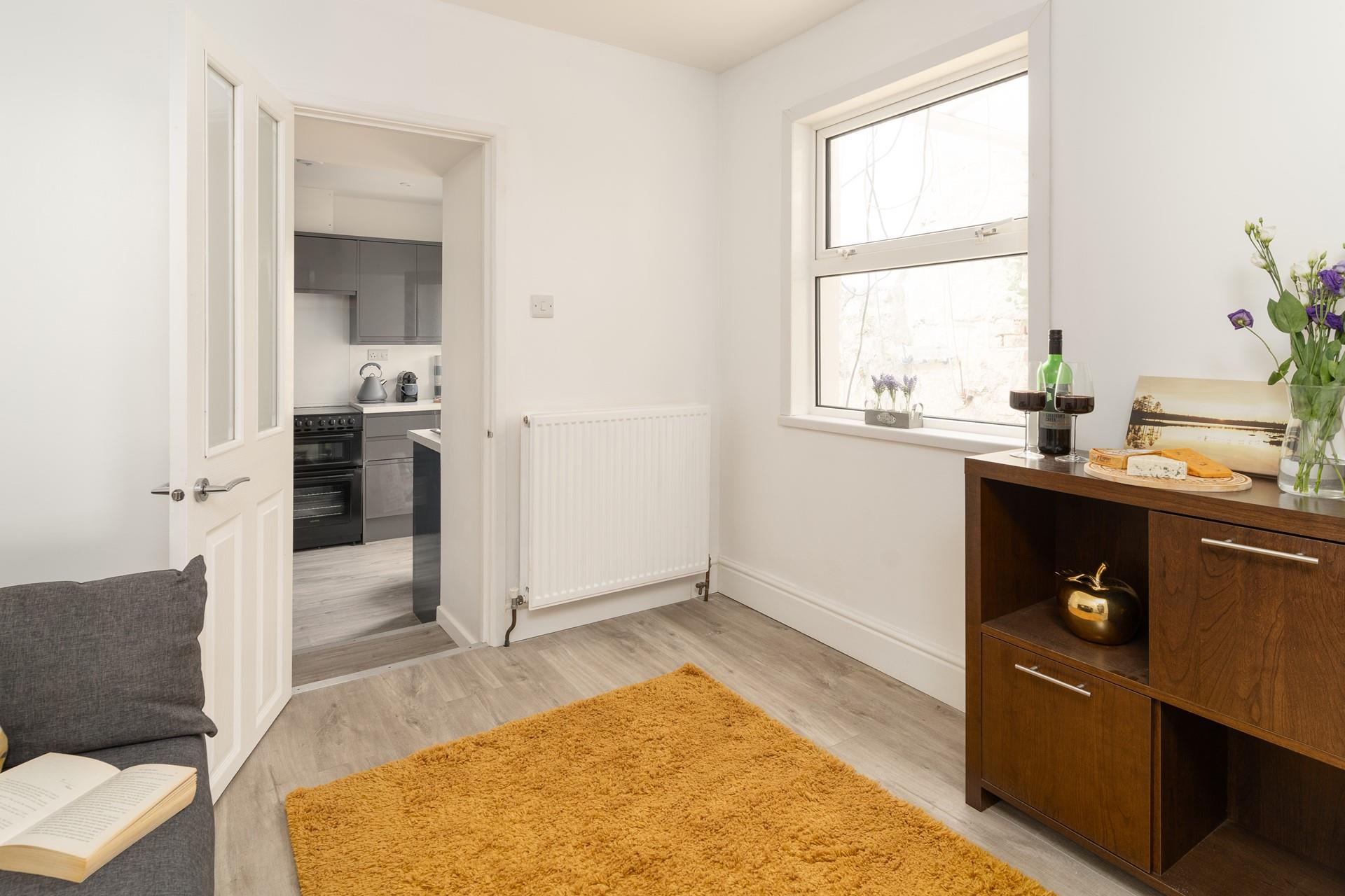 From the snug, step down to the stylish kitchen.