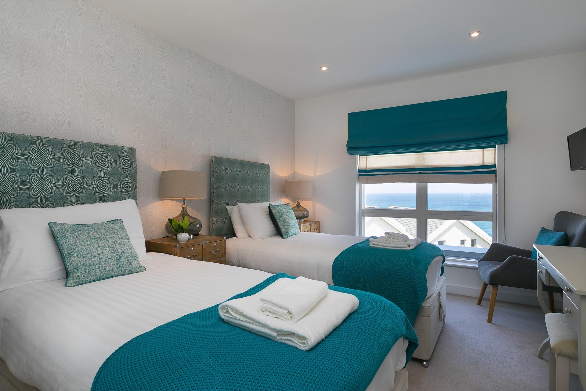 Bedroom 2 has twin beds and gorgeous sea views.