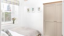 The double bedroom features stylish furniture to pack all your clothes away when you arrive.