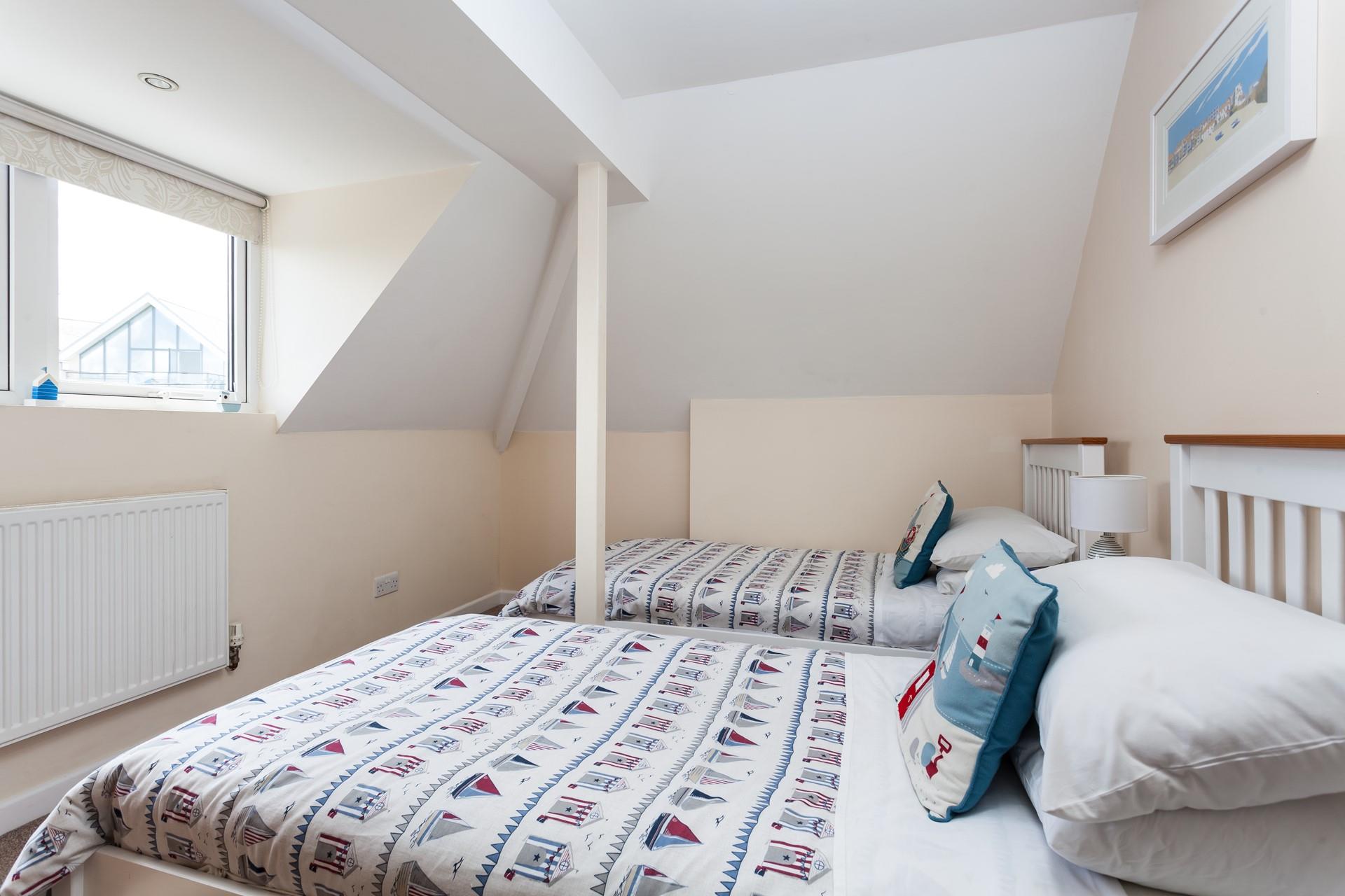 Bedroom 2 has twin beds perfect for kids or adults to enjoy a restful night's slumber.