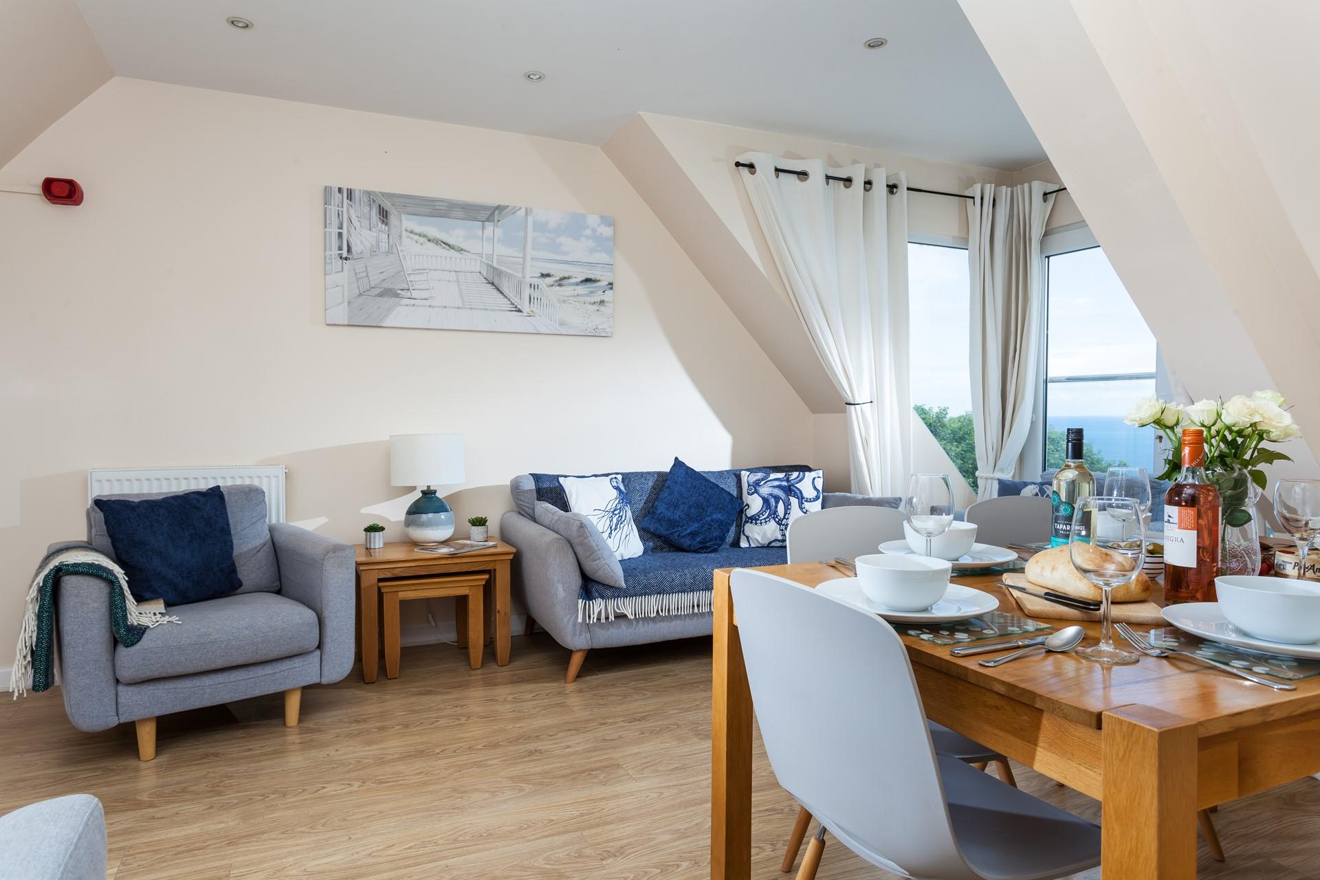 The open plan sitting/ dining room offers guests a space to relax and dine together.