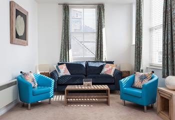 The sitting room is beautifully furnished and provides a cosy space to cuddle up in the evening.