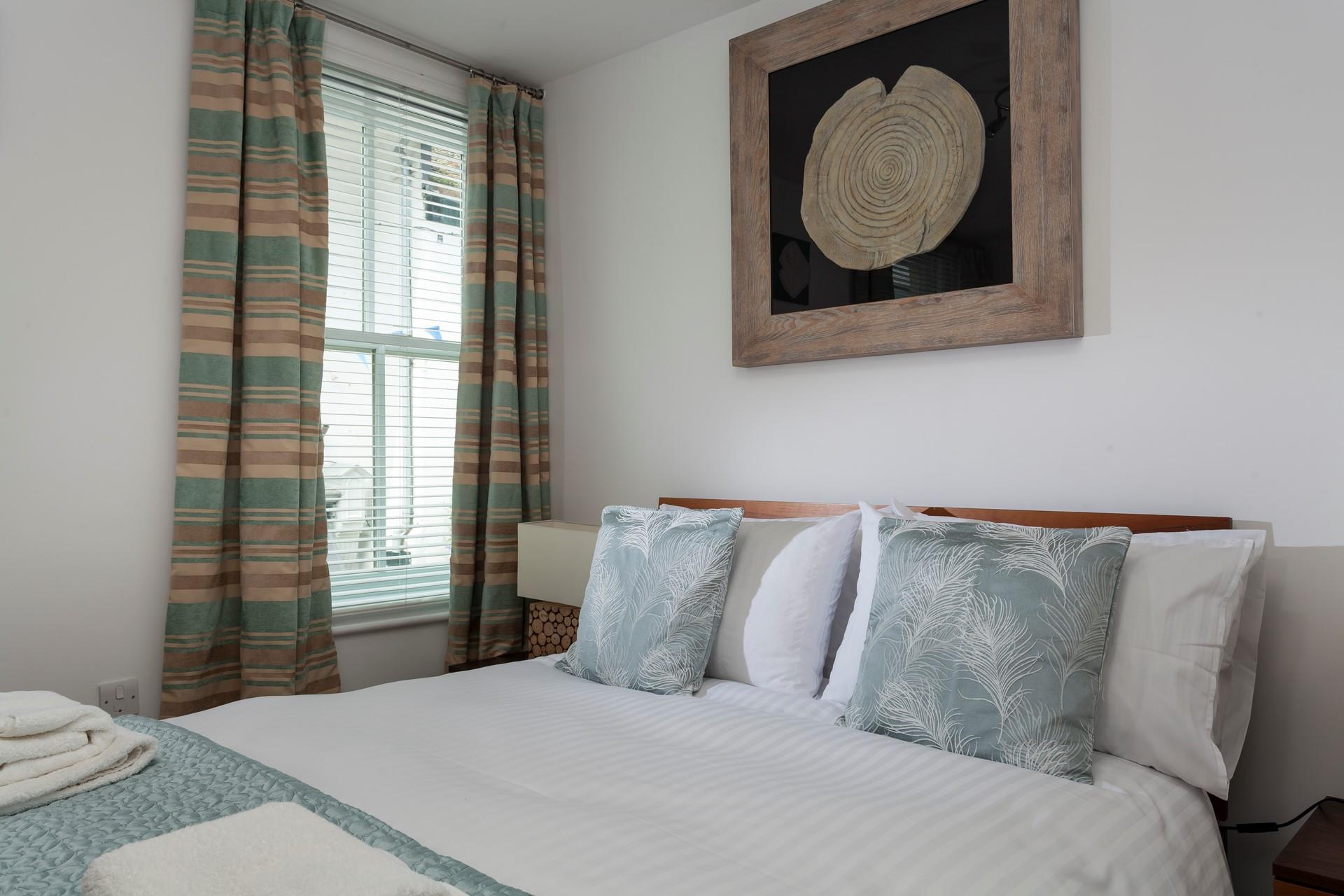 The bedroom features cosy interiors and pastel colours.