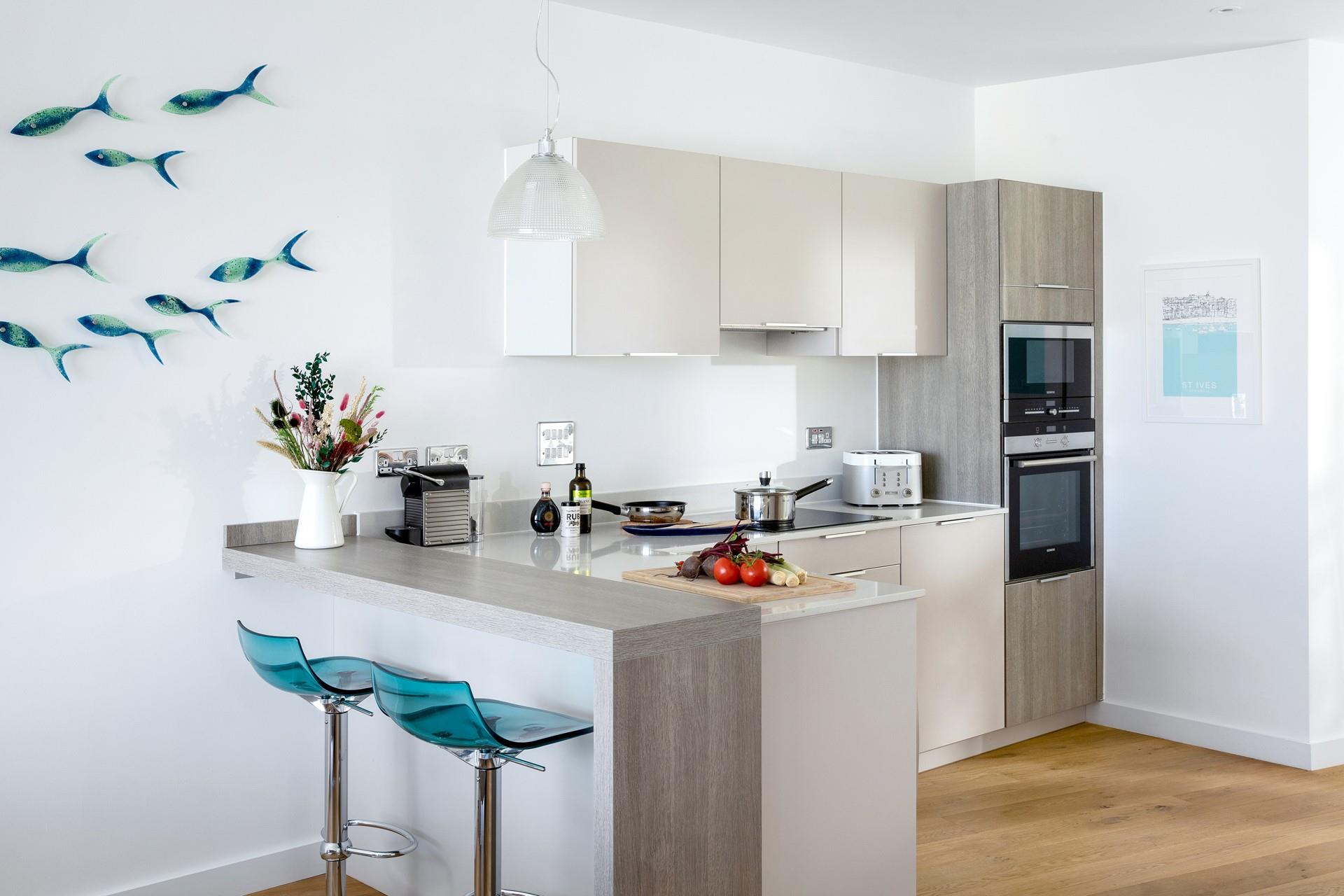 The modern and sleek kitchen is well-equipped for the chef of the family to cook up a storm.