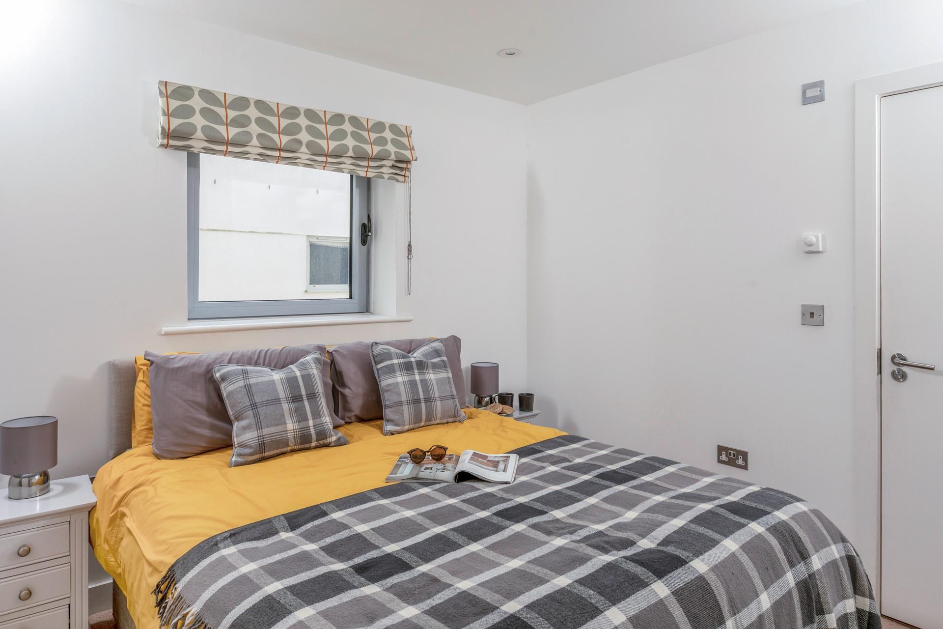 Pops of colour brighten up the chic bedroom.