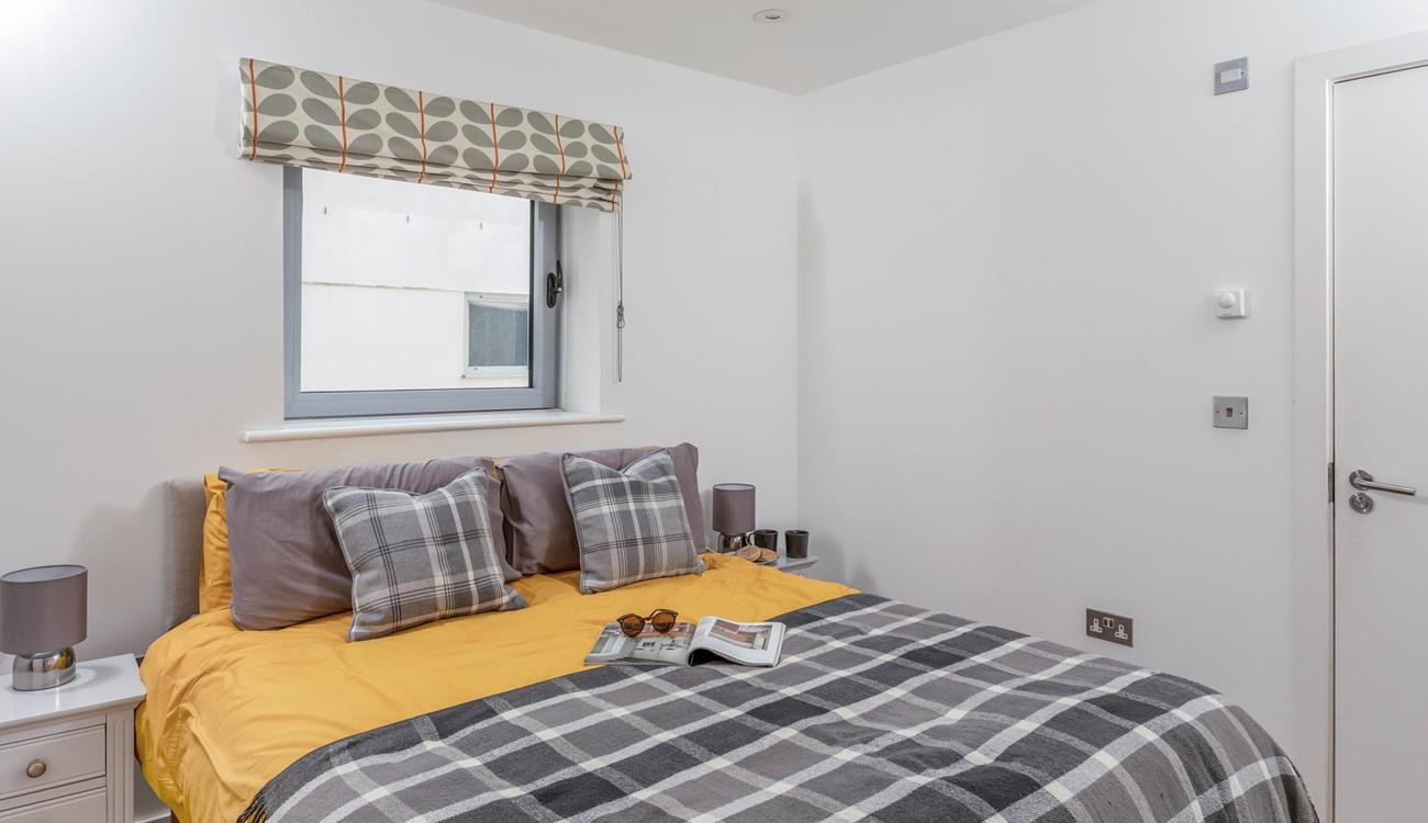 Pops of colour brighten up the chic bedroom.