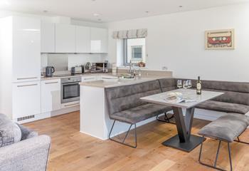 The kitchen is modern and sleek with space for the whole family to sit around the dining table.